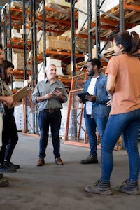 Team huddle in warehouse